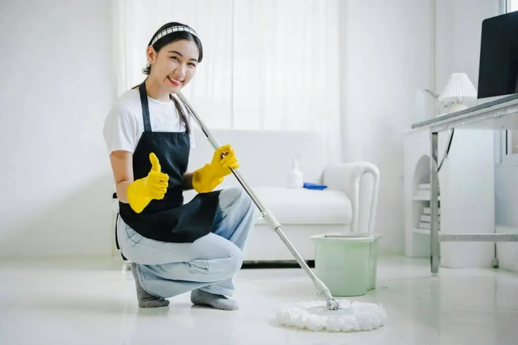 young woman mopping floor for a vacate cleaning and bond cleaning service