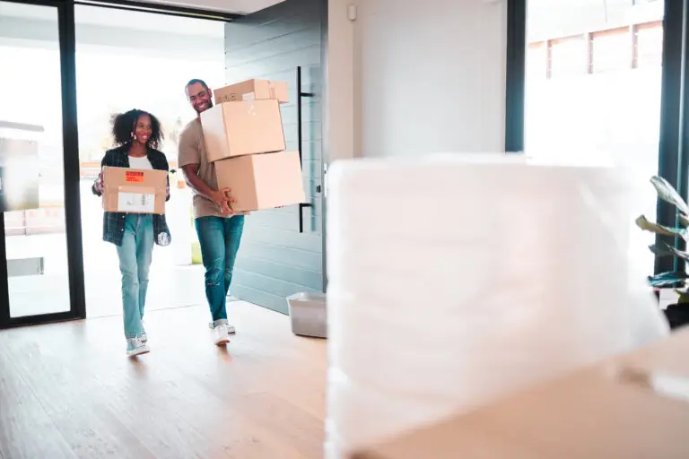 Father and young daughter unpacking boxes in their new Perth home