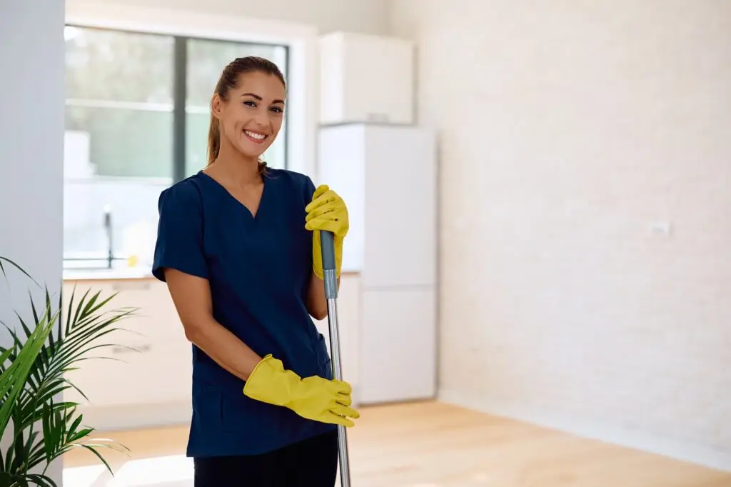 Portrait of professional female cleaner at work looking at camera.
